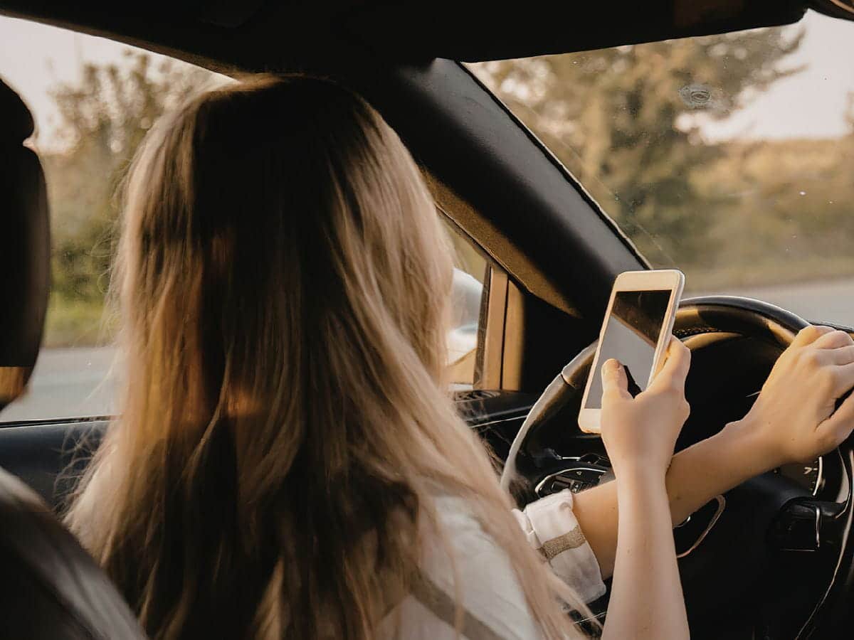 person using a phone while driving