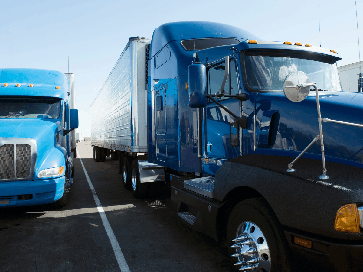 two 18-wheeler trucks side by side
